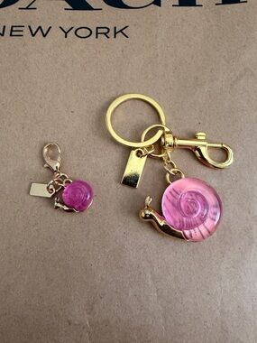 New mommy and baby Snail Bag Charms keychain. 3D snail featuring a pink shell.